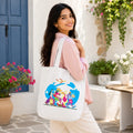 Model Holding PaintzStories "Travel Tales" Artistic Tote Bag – Eco-Friendly Cotton Canvas