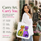 Woman Carrying PaintzStories "Two Fancy Cats" Artistic Tote Bag on Her Shoulder